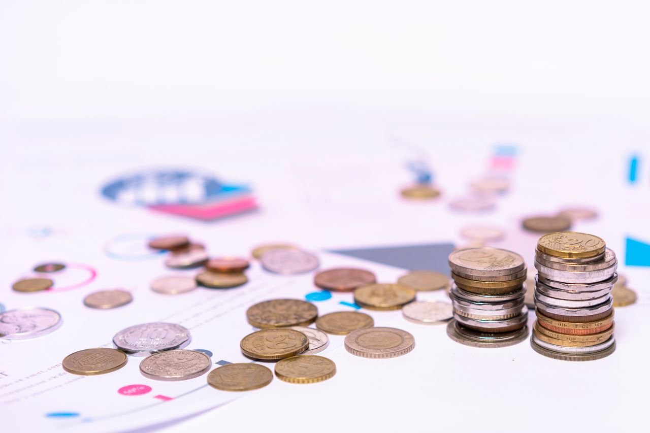 Stack of coins beside financial documents, weighing whether to incorporate in Ontario