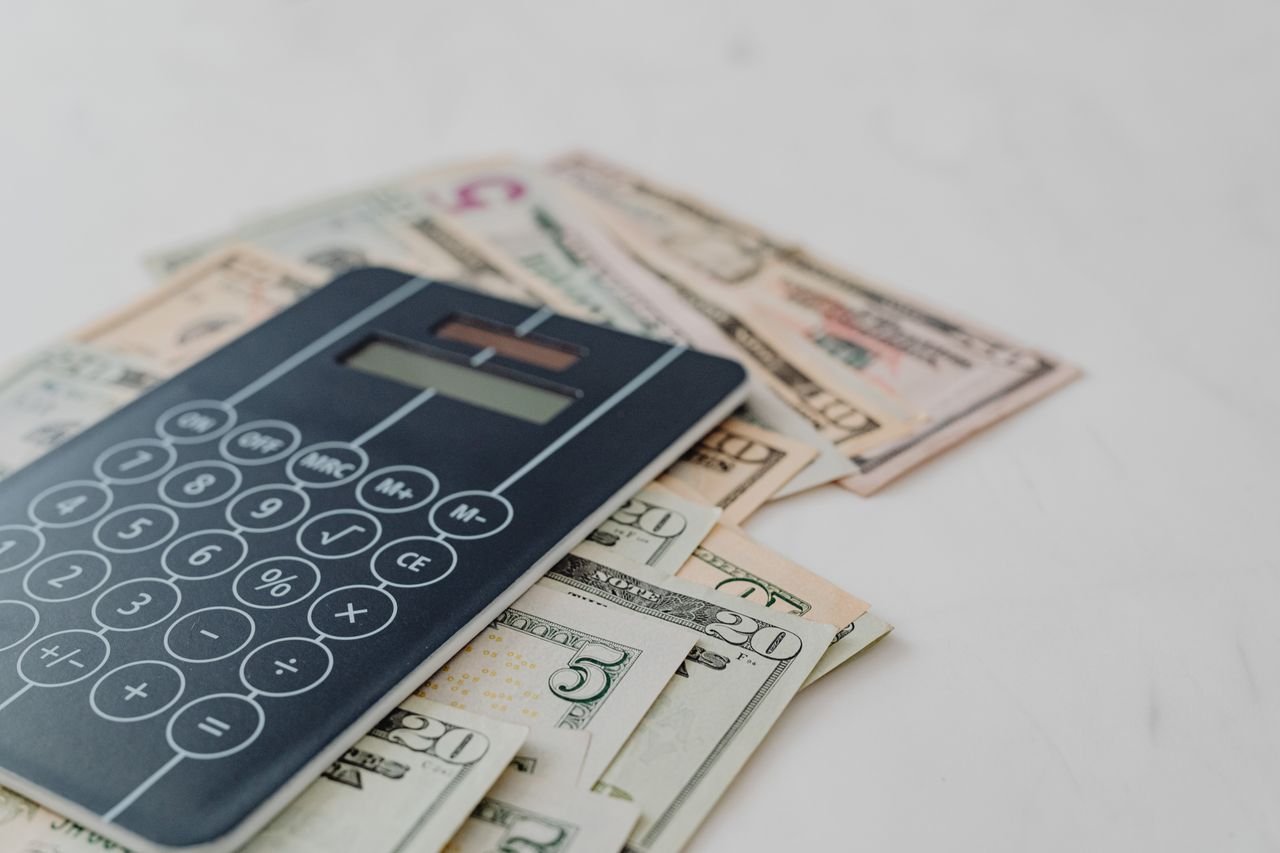 Calculator on banknotes, representing GST/HST calculations for Ontario businesses