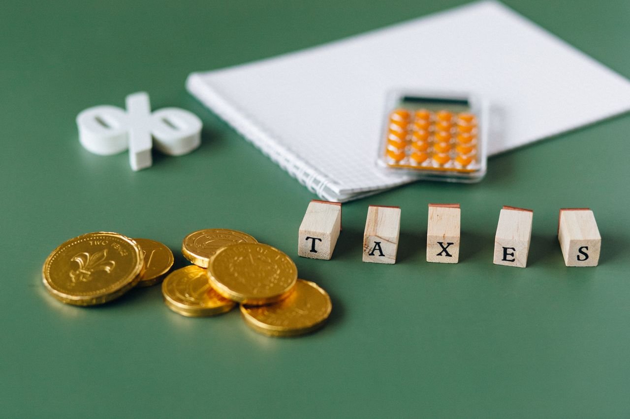 Coins and a calculator beside the word taxes, for claiming the SR&ED tax credit