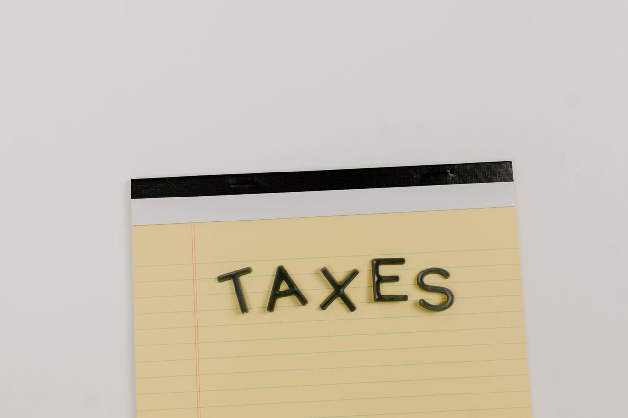 The word taxes on a yellow notepad, a reminder to pay CRA tax instalments on time