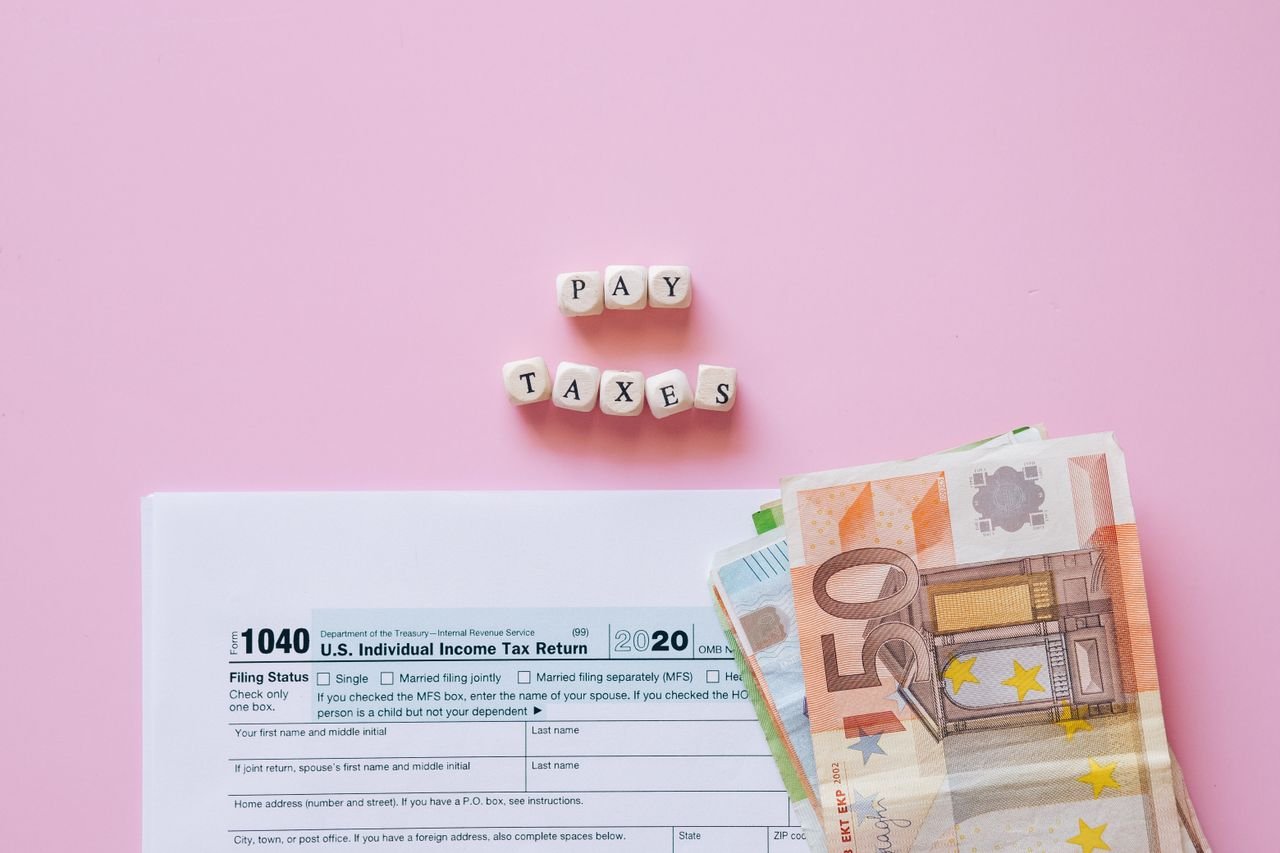 Tax form with banknotes and pay taxes blocks for filing a T2 corporate tax return